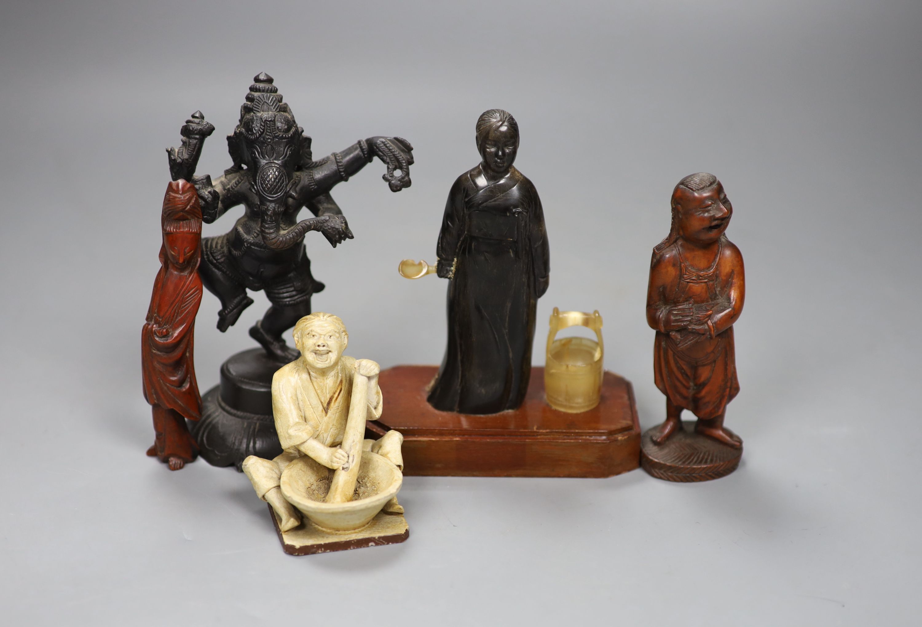 A Chinese horn figure of a lady, 14.3 cm high, two carved wood figures and A Japanese pottery seated figure